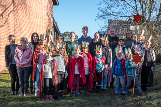Die Sternsingerkinder, -jugendlichen und die Teammitglieder haben im Garten fr Viele(s) zum Gruppenbild aufgestellt.